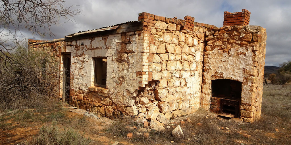 Photo of a cottage with a crumbling foundation